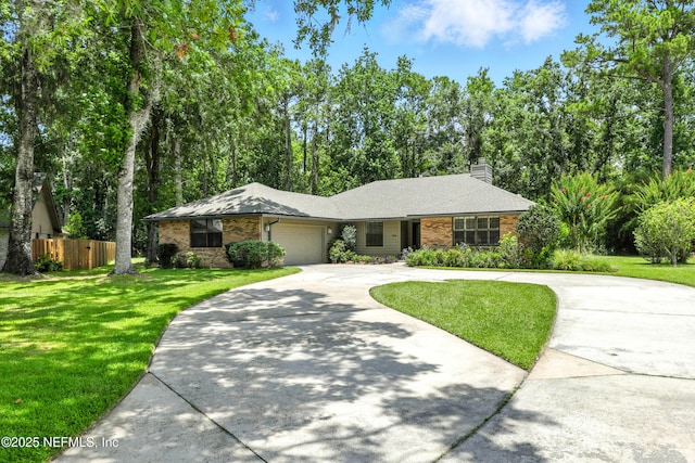 726 Arran Ct, Orange Park, FL 32073 - single story home featuring a garage, concrete driveway, brick siding, and a chimney