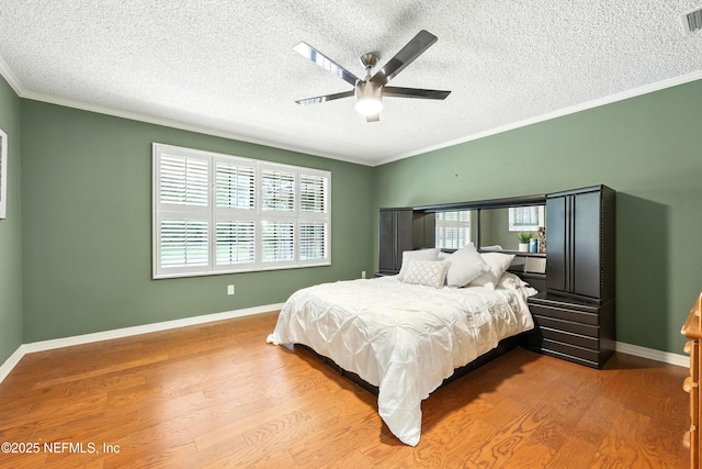 726 Arran Ct, Orange Park, FL 32073 - bedroom featuring wood finished floors, a textured ceiling, crown molding, and ceiling fan