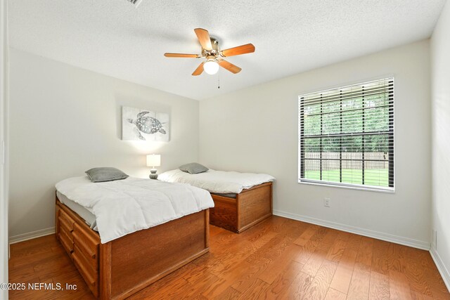 726 Arran Ct, Orange Park, FL 32073 - bedroom with wood finished floors, a textured ceiling, and ceiling fan