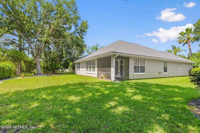 1517 Remington Way, Saint Augustine, FL 32084 - back of house with a sunroom, a yard, and stucco siding