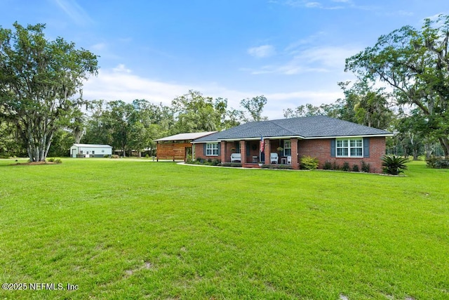 26122 Sheared Stokes Rd, Hilliard, FL 32046 - rear view of property featuring a porch, a lawn, and brick siding