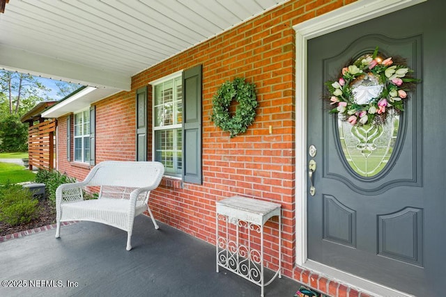 26122 Sheared Stokes Rd, Hilliard, FL 32046 - property entrance featuring covered porch and brick siding