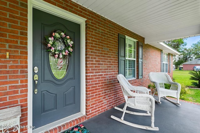 26122 Sheared Stokes Rd, Hilliard, FL 32046 - view of exterior entry with covered porch and brick siding