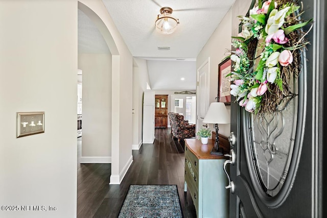 26122 Sheared Stokes Rd, Hilliard, FL 32046 - foyer featuring arched walkways and dark wood-type flooring