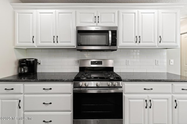 26122 Sheared Stokes Rd, Hilliard, FL 32046 - kitchen with stainless steel appliances, white cabinetry, backsplash, and dark stone counters