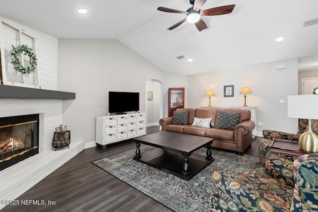 26122 Sheared Stokes Rd, Hilliard, FL 32046 - living area with vaulted ceiling, a ceiling fan, arched walkways, wood finished floors, and a fireplace