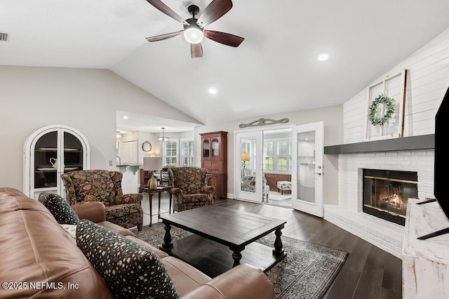 26122 Sheared Stokes Rd, Hilliard, FL 32046 - living area with vaulted ceiling, a ceiling fan, plenty of natural light, a fireplace, and wood finished floors