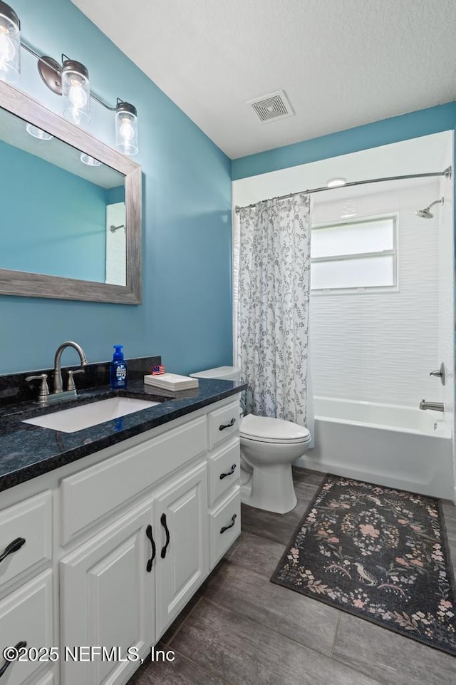 26122 Sheared Stokes Rd, Hilliard, FL 32046 - full bathroom with vanity, shower / tub combo with curtain, wood finished floors, and a textured ceiling