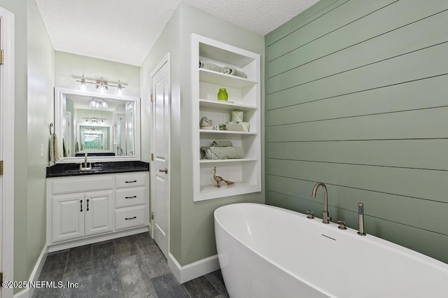 26122 Sheared Stokes Rd, Hilliard, FL 32046 - full bathroom with a freestanding tub, vanity, wood finished floors, a textured ceiling, and wood walls