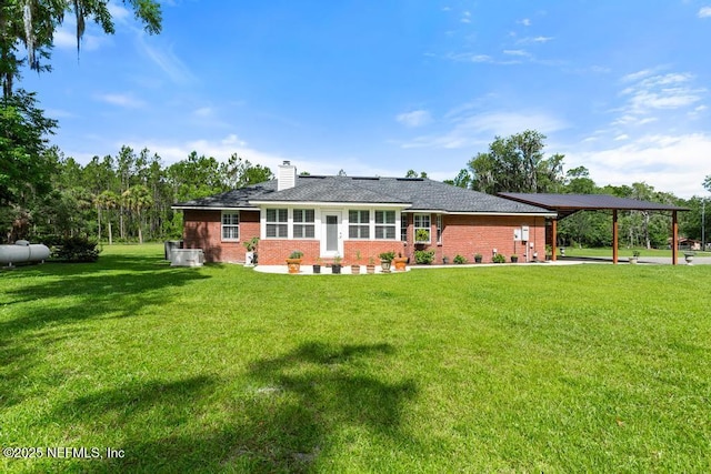 26122 Sheared Stokes Rd, Hilliard, FL 32046 - back of property featuring a chimney, a lawn, brick siding, and a carport