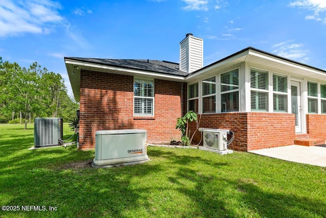 26122 Sheared Stokes Rd, Hilliard, FL 32046 - back of house with brick siding, a chimney, and a yard