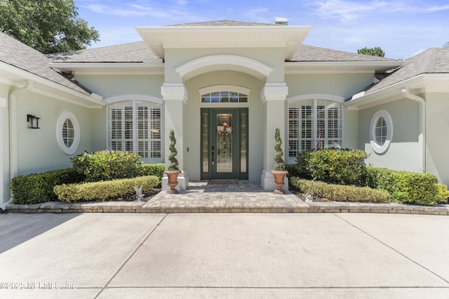 1317 Garrison Dr, Saint Augustine, FL 32092 - property entrance featuring roof with shingles and stucco siding