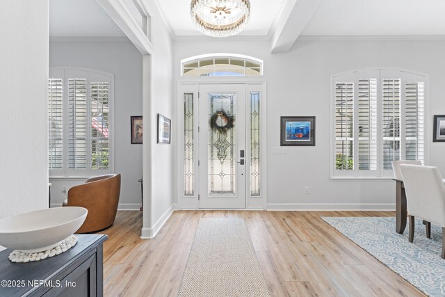 1317 Garrison Dr, Saint Augustine, FL 32092 - foyer with light wood finished floors, ornamental molding, a chandelier, and beamed ceiling