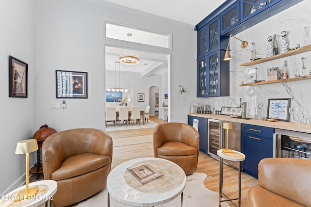 1317 Garrison Dr, Saint Augustine, FL 32092 - indoor wet bar with light wood-style floors, beverage cooler, arched walkways, and a chandelier