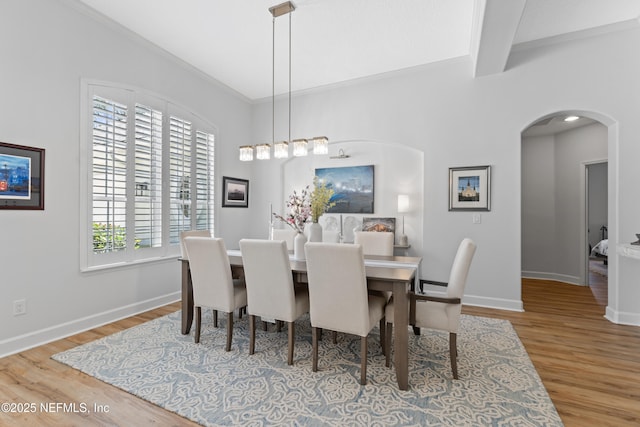1317 Garrison Dr, Saint Augustine, FL 32092 - dining space with arched walkways, wood finished floors, beam ceiling, and ornamental molding