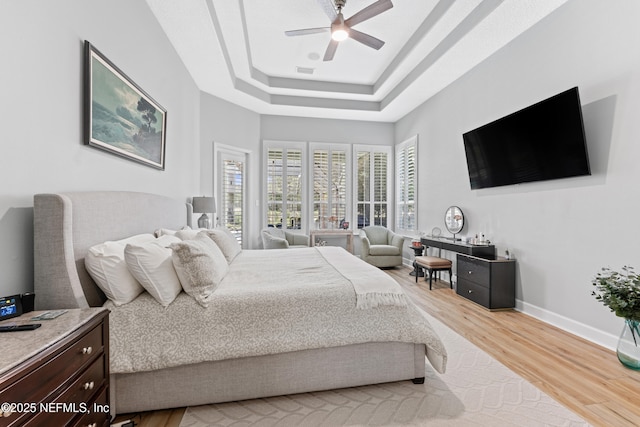 1317 Garrison Dr, Saint Augustine, FL 32092 - bedroom featuring light wood finished floors, a tray ceiling, and ceiling fan
