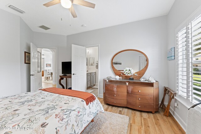 1317 Garrison Dr, Saint Augustine, FL 32092 - bedroom with light wood-style floors, a ceiling fan, and ensuite bathroom