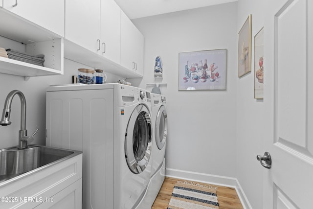 1317 Garrison Dr, Saint Augustine, FL 32092 - washroom featuring cabinet space, washing machine and dryer, and light wood finished floors