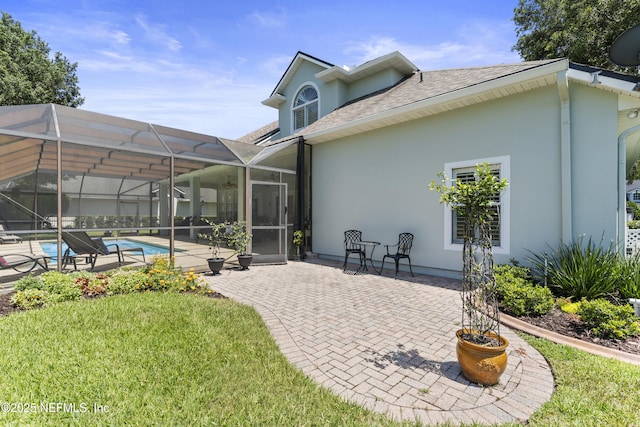 1317 Garrison Dr, Saint Augustine, FL 32092 - back of house featuring stucco siding, a patio, a yard, and an outdoor pool