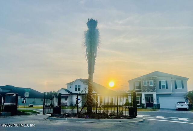 359 Holly Landing Way, Saint Augustine, FL 32092 - property at dusk featuring a garage and asphalt driveway