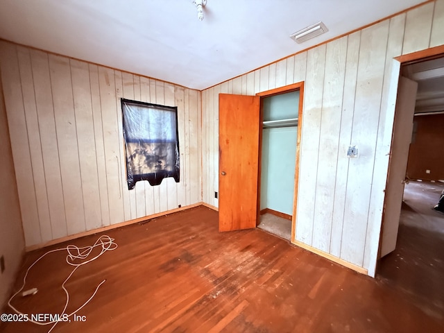 10521 Briarcliff Rd E, Jacksonville, FL 32218 - unfurnished bedroom with wood finished floors and wooden walls
