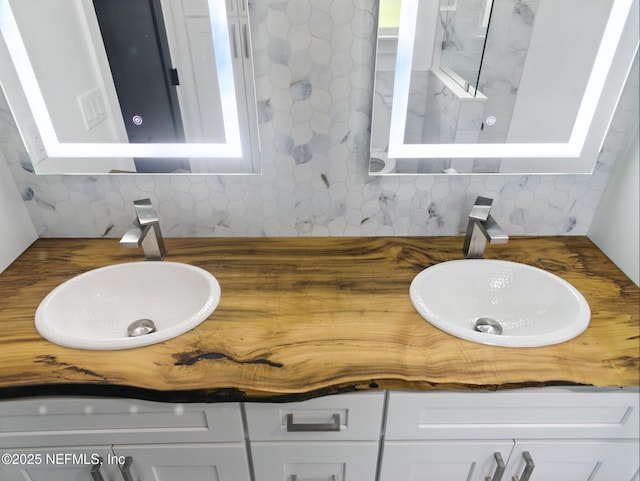 432 SE 55th St, Keystone Heights, FL 32656 - bathroom featuring double vanity and decorative backsplash