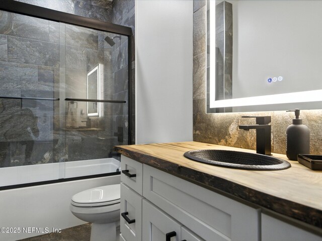 432 SE 55th St, Keystone Heights, FL 32656 - bathroom with vanity and shower / bath combination with glass door