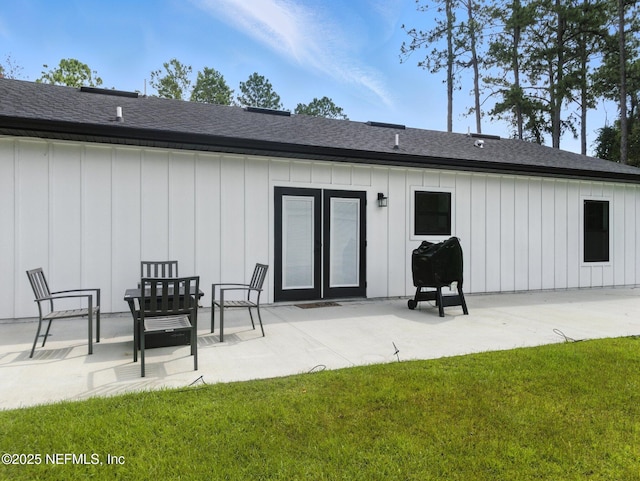 432 SE 55th St, Keystone Heights, FL 32656 - rear view of house featuring board and batten siding, a lawn, a patio area, and a shingled roof