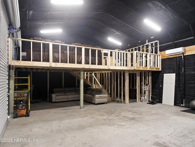 432 SE 55th St, Keystone Heights, FL 32656 - miscellaneous room featuring lofted ceiling, a wall mounted air conditioner, and concrete floors