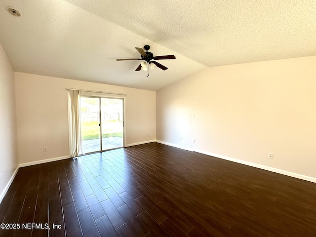 45575 Ingleham Cir, Callahan, FL 32011 - spare room with a ceiling fan, vaulted ceiling, dark wood-style flooring, and a textured ceiling