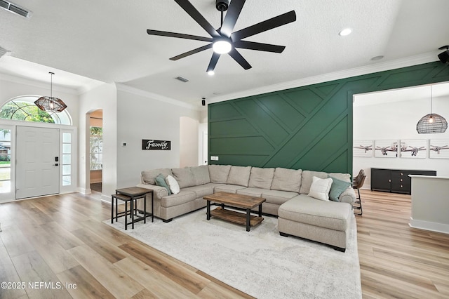 4342 Richmond Park Dr E, Jacksonville, FL 32224 - living area featuring arched walkways, crown molding, a ceiling fan, light wood-style flooring, and recessed lighting