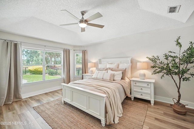 4342 Richmond Park Dr E, Jacksonville, FL 32224 - bedroom with a textured ceiling, light wood-style floors, and a ceiling fan