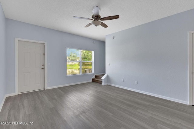 212 Northbridge Ct, Saint Johns, FL 32259 - empty room with wood finished floors, ceiling fan, a textured ceiling, and stairs