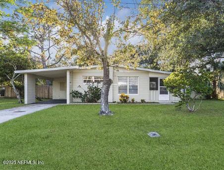 1869 Arden Way, Jacksonville Beach, FL 32250 - ranch-style house with a carport, concrete driveway, and a front lawn