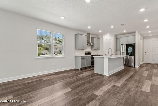 94954 Colnago Ct, Fernandina Beach, FL 32034 - kitchen featuring appliances with stainless steel finishes, gray cabinets, wall chimney range hood, recessed lighting, and light countertops