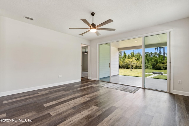 94954 Colnago Ct, Fernandina Beach, FL 32034 - empty room with a ceiling fan, dark wood-style floors, and a textured ceiling