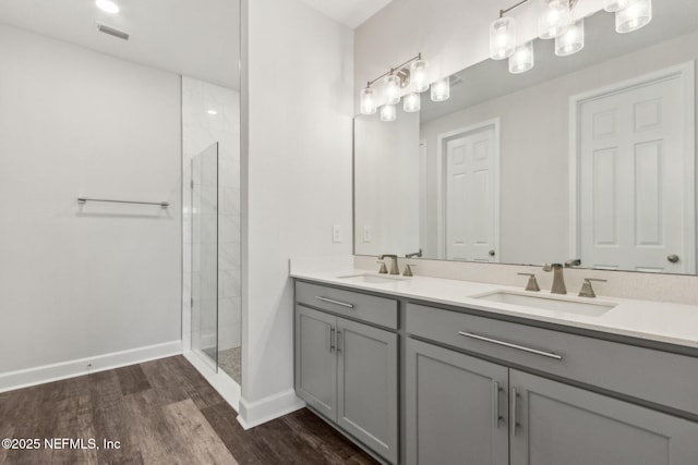 94954 Colnago Ct, Fernandina Beach, FL 32034 - bathroom with double vanity, wood finished floors, and tiled shower