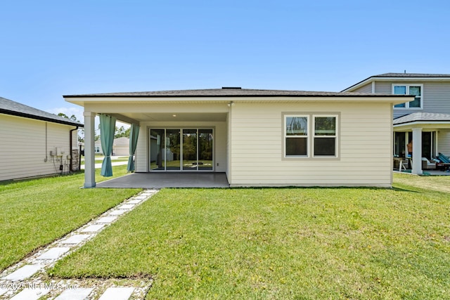 94954 Colnago Ct, Fernandina Beach, FL 32034 - back of house with a patio and a lawn