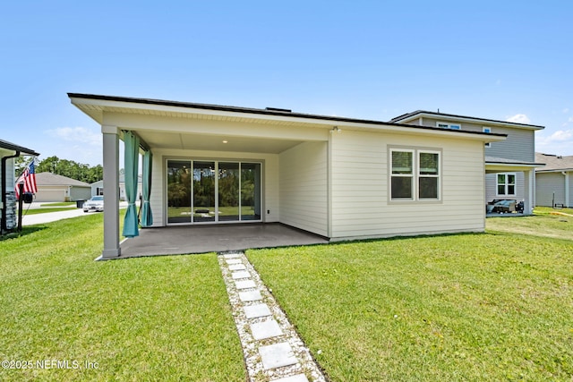 94954 Colnago Ct, Fernandina Beach, FL 32034 - back of house featuring a patio area and a yard