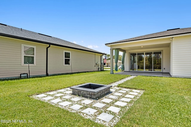 94954 Colnago Ct, Fernandina Beach, FL 32034 - view of green lawn featuring a fire pit and a patio area