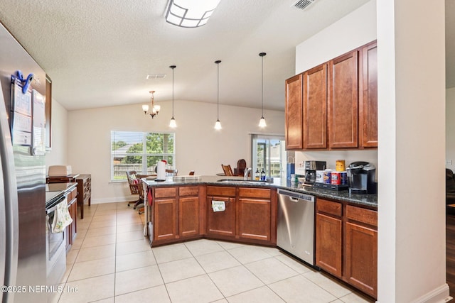 2947 Vianey Pl, Green Cove Springs, FL 32043 - kitchen featuring stainless steel appliances, a peninsula, plenty of natural light, vaulted ceiling, and brown cabinetry