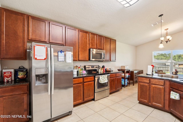 2947 Vianey Pl, Green Cove Springs, FL 32043 - kitchen featuring stainless steel appliances, vaulted ceiling, dark countertops, light tile patterned floors, and pendant lighting