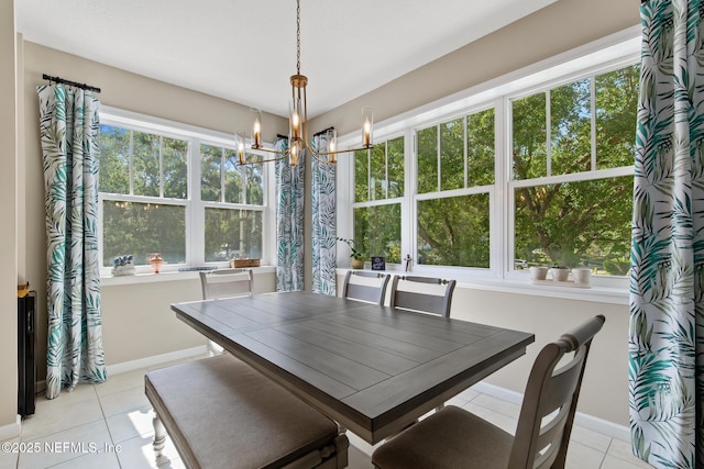 308 High Tide Dr Unit 201, Saint Augustine, FL 32080 - dining room with light tile patterned floors, healthy amount of natural light, and a chandelier