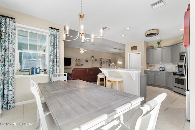 308 High Tide Dr Unit 201, Saint Augustine, FL 32080 - dining area featuring a chandelier, light tile patterned floors, recessed lighting, and ceiling fan