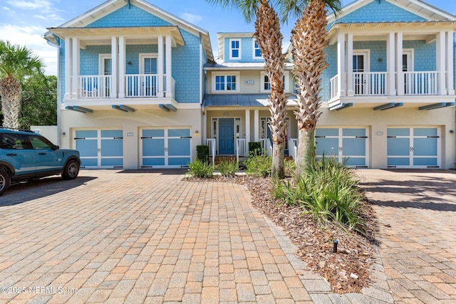 308 High Tide Dr Unit 201, Saint Augustine, FL 32080 - view of front of home featuring a garage, driveway, a balcony, and stucco siding