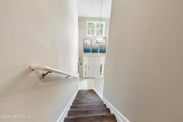 308 High Tide Dr Unit 201, Saint Augustine, FL 32080 - stairway featuring a chandelier and wood finished floors