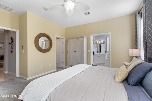 308 High Tide Dr Unit 201, Saint Augustine, FL 32080 - carpeted bedroom featuring ensuite bath and a ceiling fan