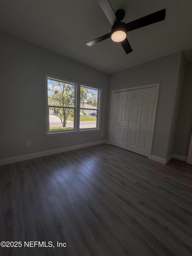 5408 Potomac Ave, Jacksonville, FL 32254 - unfurnished bedroom with dark wood-style floors, a closet, and a ceiling fan