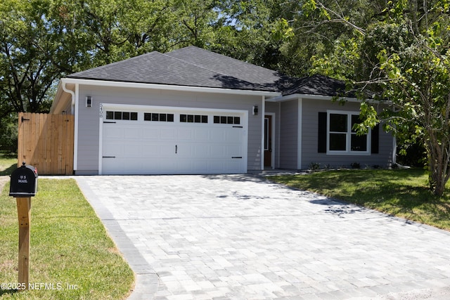 5408 Potomac Ave, Jacksonville, FL 32254 - ranch-style house with decorative driveway, an attached garage, and a shingled roof