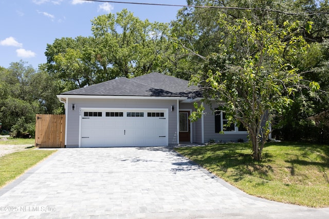 5408 Potomac Ave, Jacksonville, FL 32254 - single story home featuring decorative driveway, a front lawn, an attached garage, and a shingled roof
